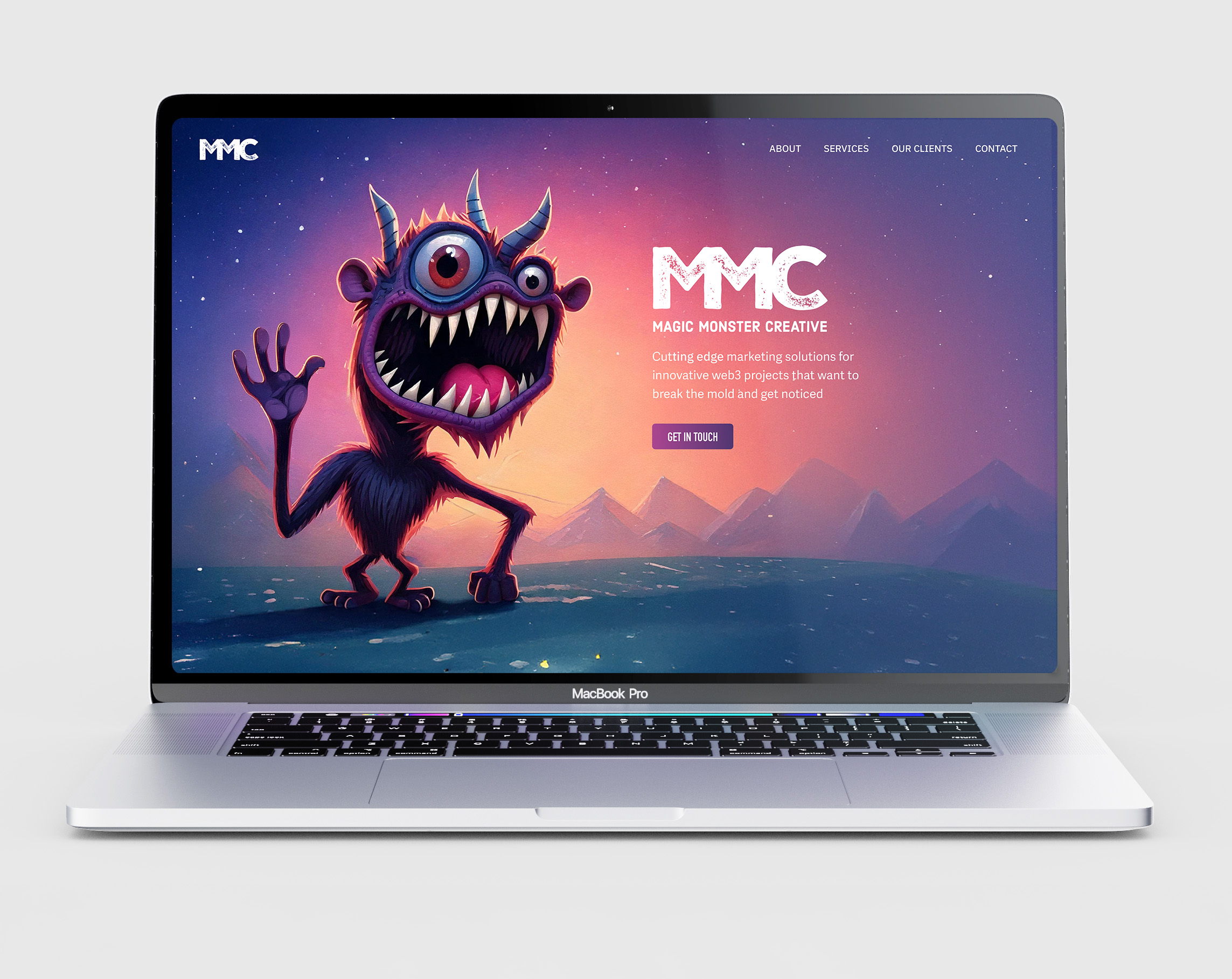 The Magic Monster Creative homepage on a laptop: the monster waving beside the MMC lockup and a Get In Touch button.